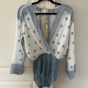 Free people, intimately… Blue and white bodysuit with lace.